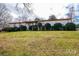 Brick ranch house with landscaped lawn and mature shrubs at 641 20Th Avenue Nw Dr, Hickory, NC 28601