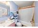 Clean bathroom with a single sink vanity and shower/tub combo at 6534 Monteith Dr, Charlotte, NC 28213