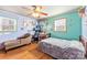 Well-lit bedroom with hardwood floors and a ceiling fan at 6534 Monteith Dr, Charlotte, NC 28213