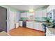 Kitchen features hardwood floors and white cabinets at 6534 Monteith Dr, Charlotte, NC 28213