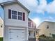 Two-story house with a gray exterior, white garage door, and burgundy shutters at 6621 Pennacook Dr, Charlotte, NC 28214