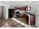 Kitchen with dark brown cabinetry, black appliances, and tile flooring at 6621 Pennacook Dr, Charlotte, NC 28214