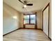 Bright bedroom with wood-look floors, ceiling fan, and double-door closet at 69 Saint Charles Ct, Hickory, NC 28601