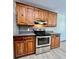 Kitchen with wood cabinets, stainless steel appliances, and tin backsplash at 69 Saint Charles Ct, Hickory, NC 28601