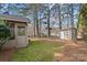 The backyard features a shed, mossy lawn, and tall trees at 709 Falls Church Rd, Charlotte, NC 28270