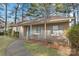 Close up of a single story home that features a front porch and light blue shutters and door at 709 Falls Church Rd, Charlotte, NC 28270