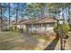 Charming single-story home with a front porch and a walkway leading to the front door at 709 Falls Church Rd, Charlotte, NC 28270