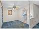 Cozy living room featuring blue carpet, ceiling fan, and view into adjacent kitchen at 709 Falls Church Rd, Charlotte, NC 28270