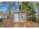 Storage shed in backyard with white trim at 709 Falls Church Rd, Charlotte, NC 28270