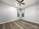 Well-lit bedroom featuring hardwood floors and two windows at 7129 Spandril Ln, Charlotte, NC 28215