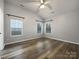 Bright bedroom with laminate wood floors and large windows at 7129 Spandril Ln, Charlotte, NC 28215