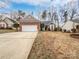 Brick ranch home with attached garage and spacious yard at 7129 Spandril Ln, Charlotte, NC 28215