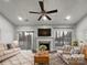 Virtually staged living room with fireplace and sliding glass doors at 7129 Spandril Ln, Charlotte, NC 28215