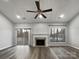 Living room with fireplace and laminate wood floors at 7129 Spandril Ln, Charlotte, NC 28215