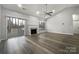 Spacious living room with fireplace and access to deck at 7129 Spandril Ln, Charlotte, NC 28215