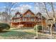 Log home with large deck, stone walkway, and mature trees at 7404 Mockingbird Ln # 73, Waxhaw, NC 28173