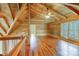 Spacious loft bedroom with wood floors and beamed ceiling, access to balcony at 7404 Mockingbird Ln # 73, Waxhaw, NC 28173