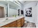 Bathroom with double vanity and peace sign decor at 7871 Petrea Ln, Charlotte, NC 28227