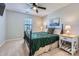 Bedroom with dark green bedding and ceiling fan at 7871 Petrea Ln, Charlotte, NC 28227