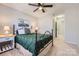 Bedroom with dark green bedding and ceiling fan at 7871 Petrea Ln, Charlotte, NC 28227