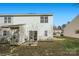 Rear view of townhouse with small patio and yard at 7871 Petrea Ln, Charlotte, NC 28227