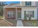 Front entrance of a brick and siding townhouse at 7871 Petrea Ln, Charlotte, NC 28227