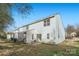 Rear view of townhouse with small patio and grassy area at 7871 Petrea Ln, Charlotte, NC 28227