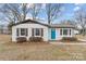 Charming ranch home with a teal front door and landscaped yard at 809 Hasty Rd, Marshville, NC 28103