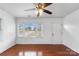 Bright living room featuring hardwood floors, large window, and ceiling fan at 809 Hasty Rd, Marshville, NC 28103