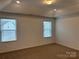 Bright bedroom with neutral carpeting and two windows at 813 Gondola Ct # 107, Salisbury, NC 28144