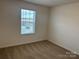 Simple bedroom with neutral carpeting and a large window at 813 Gondola Ct # 107, Salisbury, NC 28144