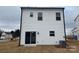 Rear view of a two-story home with vinyl siding and sliding glass door at 813 Gondola Ct # 107, Salisbury, NC 28144