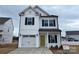 Two-story house with white siding, black shutters, and a yellow front door at 813 Gondola Ct # 107, Salisbury, NC 28144