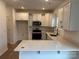 Well-equipped kitchen with white cabinets and quartz countertops at 813 Gondola Ct # 107, Salisbury, NC 28144