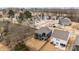 An aerial view of the property showcasing the two-story home, fenced backyard, and surrounding neighborhood at 8138 Annsborough Nw Dr, Concord, NC 28027