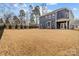 View of the house's backyard with ample lawn space and a fence, great for outdoor activities and privacy at 8138 Annsborough Nw Dr, Concord, NC 28027