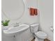 Well-lit bathroom with pedestal sink, modern fixtures, and neutral color scheme at 8138 Annsborough Nw Dr, Concord, NC 28027