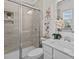 Modern bathroom with a glass-enclosed shower, white vanity, and decorative accents at 8138 Annsborough Nw Dr, Concord, NC 28027