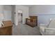 Bright Bedroom with crib, chair, and access to a walk-in closet at 8138 Annsborough Nw Dr, Concord, NC 28027