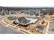 Aerial view of a community pool, tennis courts, playground, and clubhouse surrounded by neighborhood homes at 8138 Annsborough Nw Dr, Concord, NC 28027