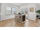 Cozy dining area with a table, four chairs, and natural light from windows and glass doors at 8138 Annsborough Nw Dr, Concord, NC 28027