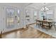 Elegant dining room with wood floors, natural light, and a view of the front door at 8138 Annsborough Nw Dr, Concord, NC 28027