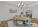 Elegant dining room featuring a chandelier, artwork, and a wooden table at 8138 Annsborough Nw Dr, Concord, NC 28027