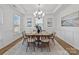 Elegant dining room featuring a chandelier, artwork, and wainscoting at 8138 Annsborough Nw Dr, Concord, NC 28027