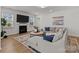 Comfortable living room featuring a fireplace, a large sectional sofa, and plenty of natural light at 8138 Annsborough Nw Dr, Concord, NC 28027