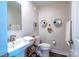 Small bathroom with white sink, toilet, and hexagon shelves at 824 Broad River Ln, Charlotte, NC 28211