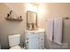 Small bathroom with white vanity and a floating shelf at 824 Broad River Ln, Charlotte, NC 28211