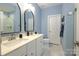 Modern bathroom with double vanity, a walk-in shower, and stylish mirrors at 824 Broad River Ln, Charlotte, NC 28211