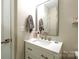 Modern bathroom with white vanity, updated fixtures, and a large mirror at 824 Broad River Ln, Charlotte, NC 28211