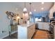 Bright kitchen with island, white cabinets, and hardwood floors at 824 Broad River Ln, Charlotte, NC 28211